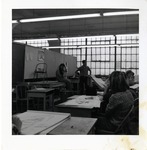 Two Students Stand in the Front of the Classroom