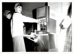 Student Pouring a Drink from A Soda Machine, Student Candids ca. 1960s